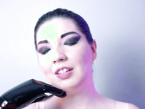 stroking her huge tits with long latex gloves